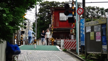 Toshima-ku Tokyo level train crossing couple walking